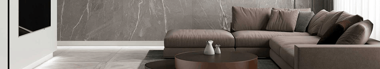 Salón moderno con sofá de tonos marrones, mesa de centro de diseño elegante y pared de piedra natural, creando un ambiente sofisticado y acogedor.