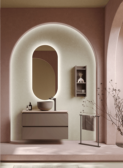 Baño elegante con diseño minimalista, lavabo circular sobre un mueble moderno, espejo de forma ovalada con iluminación integrada y detalles decorativos en tonos suaves y cálidos.
